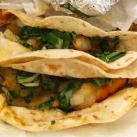 Shrimp Taco · Onion and Cilantro mix served on corn Tortilla,Choice of red or green salsa