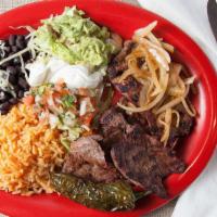 Carne Asada Plate · Carne asada served with rice, beans, sour cream, guacamole, lettuce and two tortillas of you...