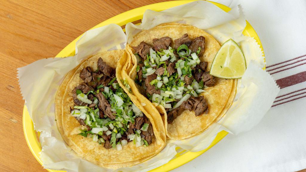 Steak Taco · Authentic Mexican taco on warm corn tortilla with onions and cilantro!.