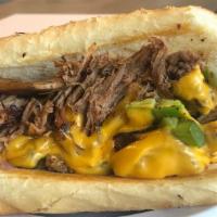 Brisket Cheesesteak · Slow Roasted Brisket w/peppers, onions, mushrooms, and American cheese. Served on a fresh fl...