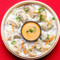 Vegetable Momo · Vegetable dumplings with potato, cabbage, cilantro, green, peas, white onion, and steam cook...