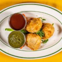 Vegetable Samosas (3) · Tasty pastry shells stuffed with potatoes, peas, and spices. (Vegan)