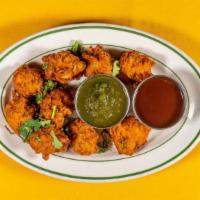 Onion Pakoda · Fried onion fritters made from a chickpea flour batter. (Vegan)