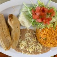Tamale Dinner · Three pork or chicken tamales wrapped in corn husk. Served with lettuce, tomato and sour cre...