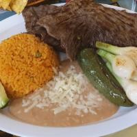 Carne Asada A La Tampiquena · Grilled skirt steak topped with a cheese enchilada. Served with sour cream, guacamole, lettu...