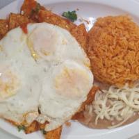 Chilaquiles · Chilaquiles – Three eggs, fried tortilla in special red sauce topped with cheese, onion, tom...