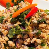 Larb Chicken Salad · Ground chicken tossed with onion, chili, ground rice, cilantro and lime juice.