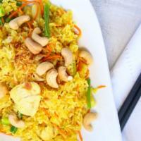 Pineapple Fried Rice · Thai fried rice with your choice of meat, onion, green peas, pineapple, carrots and egg.