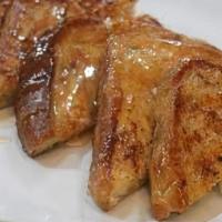 French Toast With Syrup · Three large slices of French bread dipped in egg batter and grilled golden brown. Topped wit...