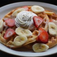 Belgian Waffles · Two Belgian waffles served with whipped butter, maple syrup and whipped cream.