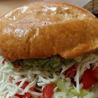 Torta · Mexican bread with your choice of meat with refried beans, lettuce, tomato, onion, cheese, a...