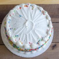 White · Cake with white buttercream icing with confetti sprinkles on the side.