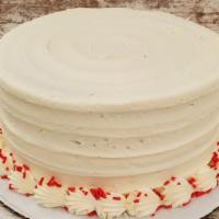 Red Velvet · Red velvet cake with cream cheese icing and red sprinkles garnishing the top.