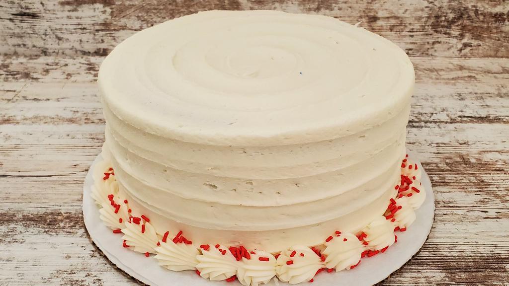 Red Velvet · Red velvet cake with cream cheese icing and red sprinkles garnishing the top.