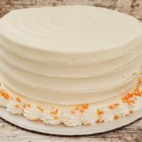 Carrot · Carrot cake with cream cheese icing and orange sprinkles garnishing the top.