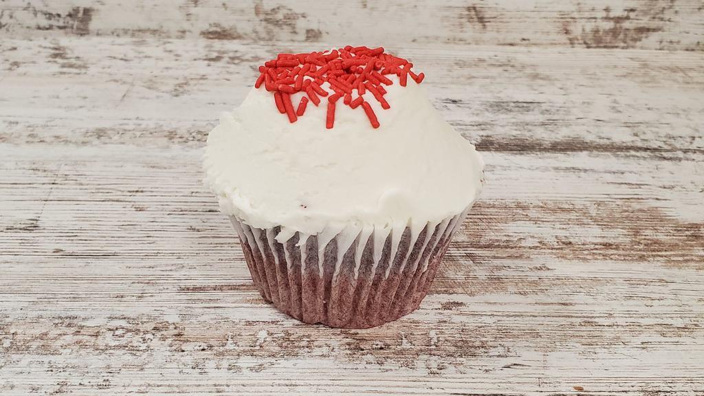 Red Velvet · Red velvet cake with cream cheese icing and topped with sprinkles.