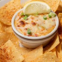 Pimento Cheese Crab Dip · Creamy crab dip topped with pepper jack cheese and served with tortilla chips.