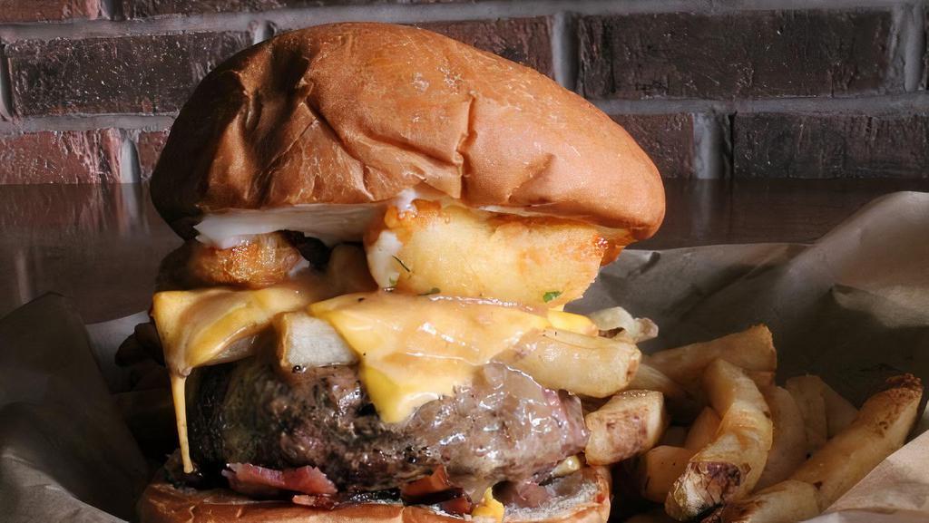 Poutine Lucy · American cheese-stuffed patty with chopped bacon, mayo, pub fries, American cheese, cheese curds and beef gravy.