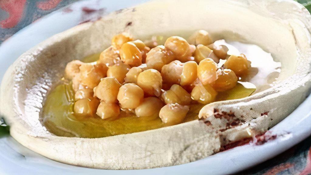 Hummus · Ground chickpeas, tahini, fresh garlic, drizzled with extra virgin olive oil and served with pita bread.