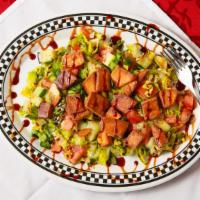 Fattoush · House specialty salad topped with fried pita bread.