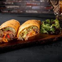 Filet Mignon Wrap · Tender filet mignon tips sautéed with mushroom and red onion wrapped in a sun-dried tomato w...