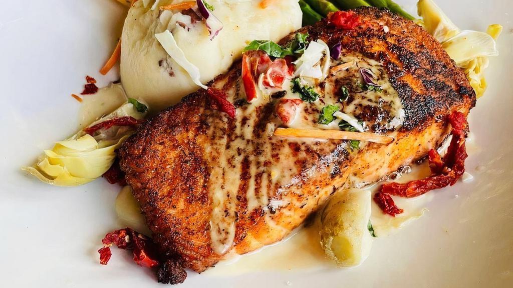 Salmon Lemoni  · Atlantic salmon smothered in a fresh lemon-oregano and caper sauce. Served with whipped potatoes and seasonal vegetables.