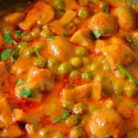 Mushroom Mutter · Mushrooms and peas cooked in a sauce.