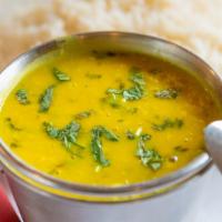 Dal Thadka · Yellow lentils made with freshly ground herbs, tempered with onions, tomatoes and cumin seeds.