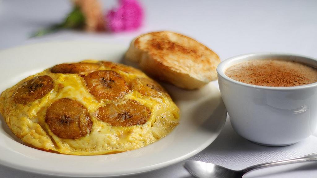 Nellie'S Breakfast Special · Tortilla Boricua, an open faced-omelet seasoned with sofrito, mozzarella cheese, tomatoes, green peppers, salchichon sausage, maduros (sweet plantains), onions, served with a cup of avena de coco (coconut oatmeal) and tostada criolla (toasted french bread)