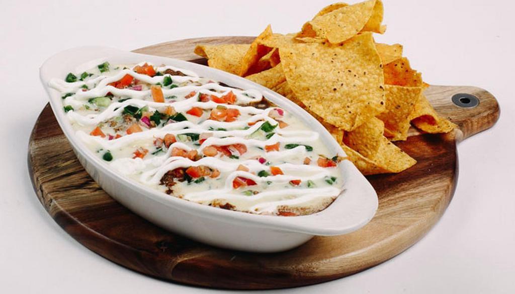 Small Nacho · Your choice of meat, refried beans, black beans, monterey jack cheese, Yabo’s queso, pico de gallo, diced jalapenos & sour cream. *Gluten free