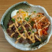 Korean Bbq Yum Yum Bowl · Marinated steak, kimchee, and sunny side up egg, served over coconut jasmine rice and topped...