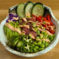 Volcano Poke Bowl · Sushi-grade ahi tuna* marinated in a lemongrass soy-ginger glaze, avocado, bell peppers, cuc...