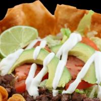 Taco Salad · Served with meat choice, beans, rice, sour cream, cheese, avocado, tomato and lettuce.