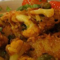 Aloo Gobi Masala · Cauliflower and potatoes dry roasted with ginger, garlic, tomatoes and cilantro.