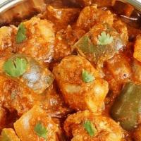 Kadhai Paneer · Homemade cheese pan sautéed with chunky onions, green peppers, and a touch of tomato gravy.