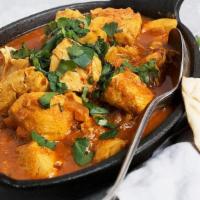 Chicken Vindaloo · Chicken cooked in tangy sauce consisting of garlic, ginger, chili, vinegar and potatoes