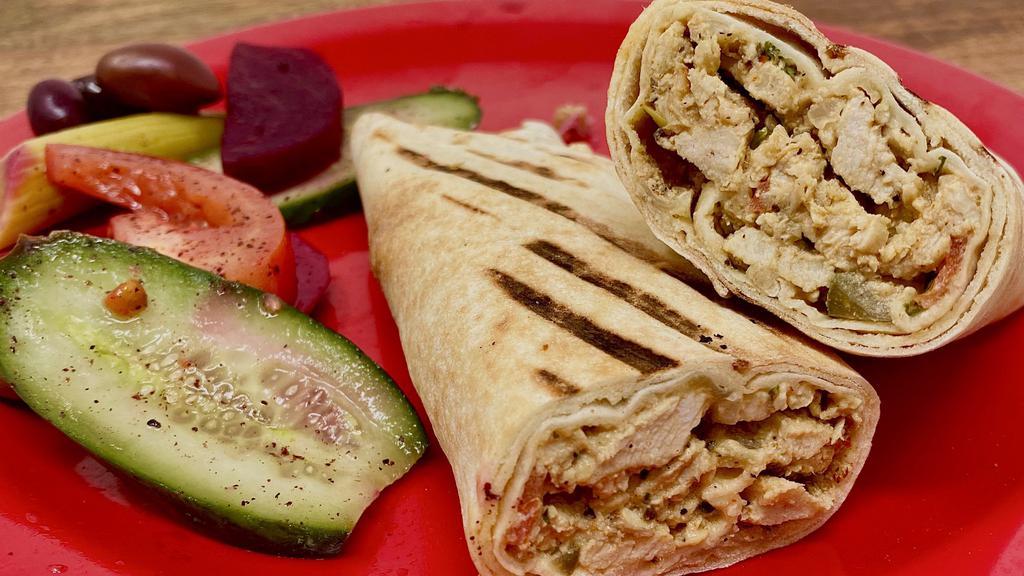 Chicken Shawarma · Marinated chicken wrapped in our freshly baked pita bread-with tahini or garlic sauce.