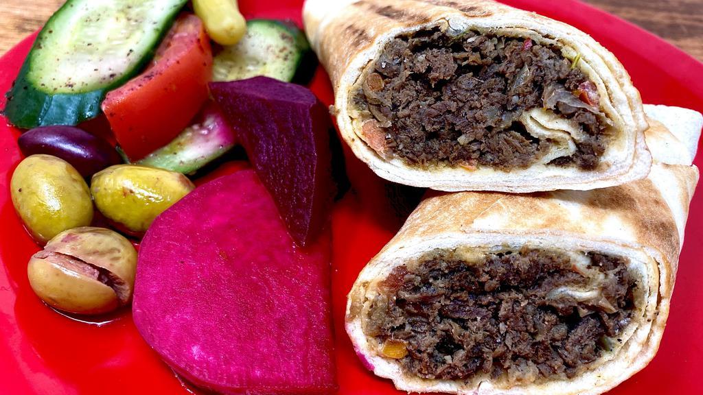 Steak Shawarma · Marinated steak wrapped in our freshly baked pita bread-with tahini or garlic sauce.