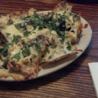 I Love My Nachos Grande · Baked with Colby cheese beans, beef, tomatoes, onions, and jalapeños served with lettuce, gu...