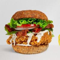 Sinful Bacon Chicken Sandwich · Crispy fried chicken, crispy bacon, lettuce, onion, tomatoes, and house mayo. Served on a wa...