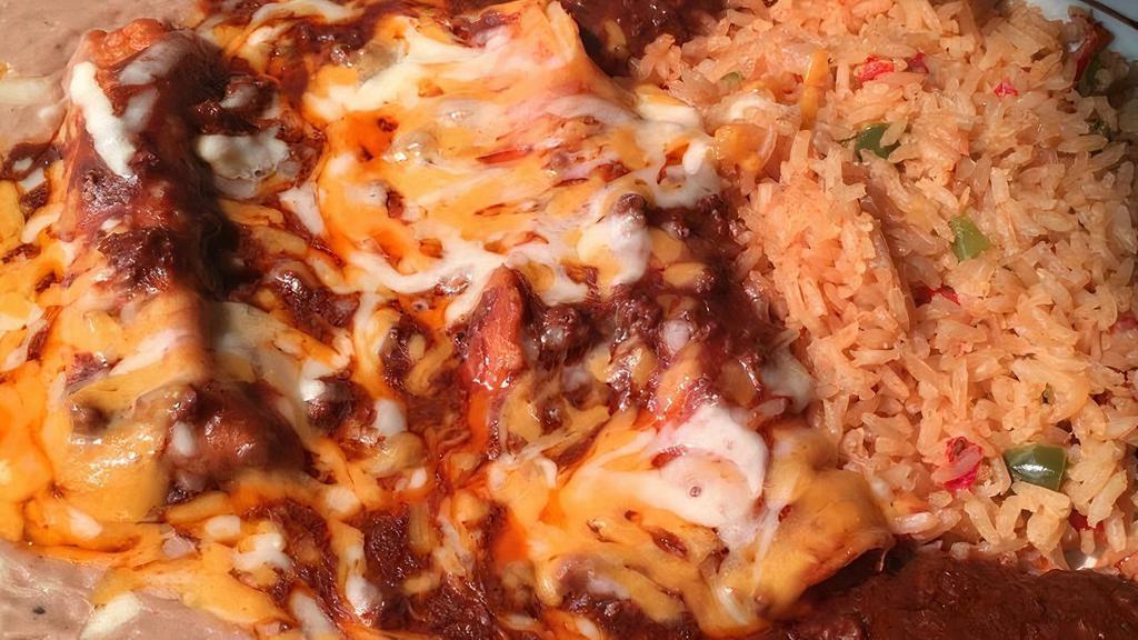 #10 (1) Cheese Enchilada, (1) Taco & (1) Tamale · With chili and cheese on top, rice and beans.