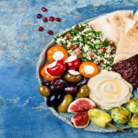 Mezze Platter · Platter with hummus, baba ganoush, stuffed grape leaves, falafel, farmers salad, and a pita ...