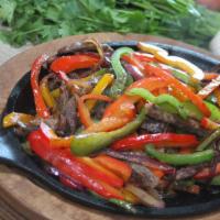 Fajitas · Fajitas are served with a side or rice, beans, sour cream and guacamole.  Choice of corn or ...