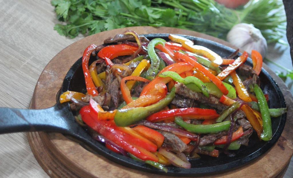Fajitas · Fajitas are served with a side or rice, beans, sour cream and guacamole.  Choice of corn or flour tortillas.