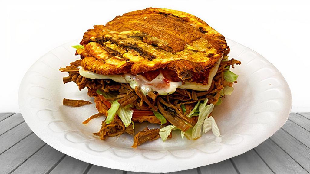 Patacones · Topped with fried plantains, lettuce, tomato, Latin grilled cheese, ham, sauces.