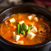 Kimchi Chigae · Kimchi stew, pork, tofu, green chili peppers, scallions.