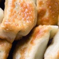 Pot Stickers · Pan-Fried Dumplings filled with pork with a side of ginger/ garlic soy sauce.