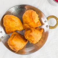 Samosa · Two patties stuffed with potatoes, green peas, and spices.