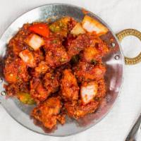 Chicken Manchurian · Green chili and spring onion chicken strips fried with Indo-Chinese spices.