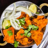 Fish Pakora · Fish marinated in spices and deep fried.